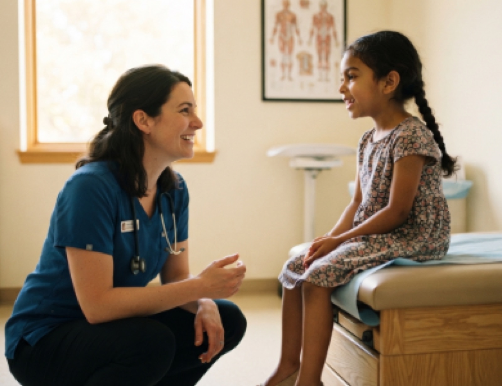 A pediatrician examining a smiling child at Ivy League Pediatrics